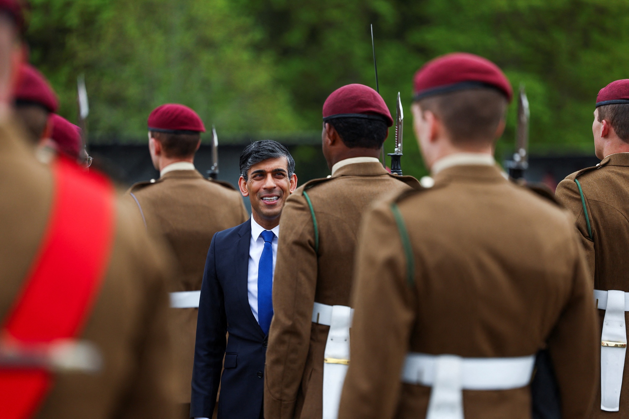 Rishi Sunak inspects a passing out parade in Cattrick, England.