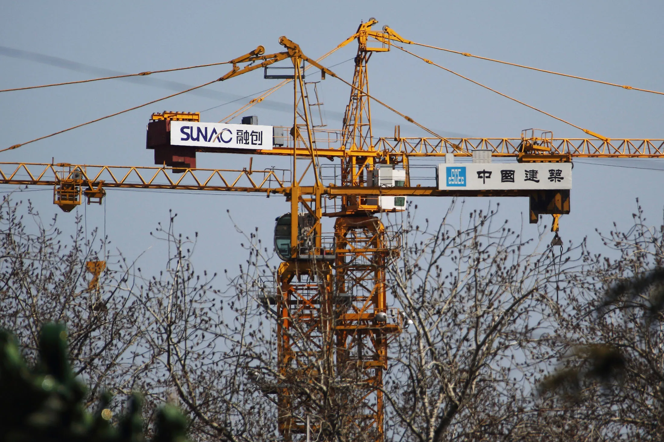 The Sunac China Holdings Ltd. logo is displayed on a crane at one of the company's construction sites in Beijing, China, on Tuesday, March 10, 2015. China set the lowest economic growth target in more than 15 years and flagged increasing headwinds that include a property slump, excess industrial capacity and disinflation.
