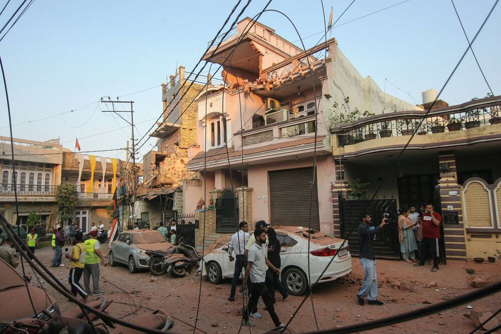 Residents gather near a house that was damaged by  Pakistani artillery shelling in Jammu on May 10, 2025.