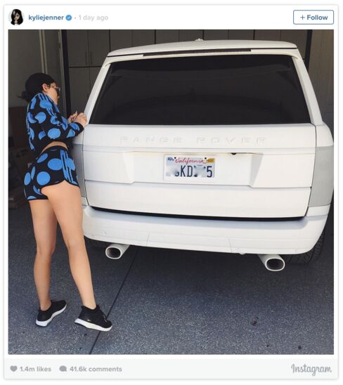Kylie Jenner, one of the social media-conscious Kardashian clan, poses with a Range Rover.