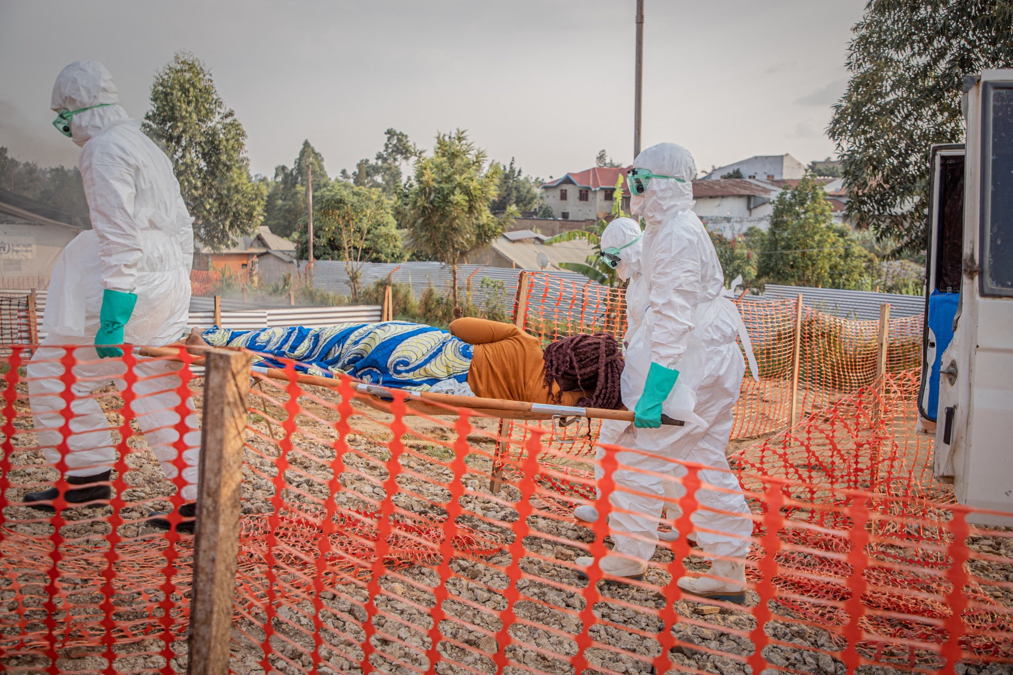 Healthcare workers carry an Ebola patient on a stretcher from an ambulance at the Ebola Treatment Center in Bunia, Ituri, in Democratic Republic of Congo.