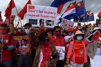 Protesters rally against the military coup and arrest of Aung San Suu Kyi in Myanmar, outside Parliament House in Canberra, Australia on Feb. 12.