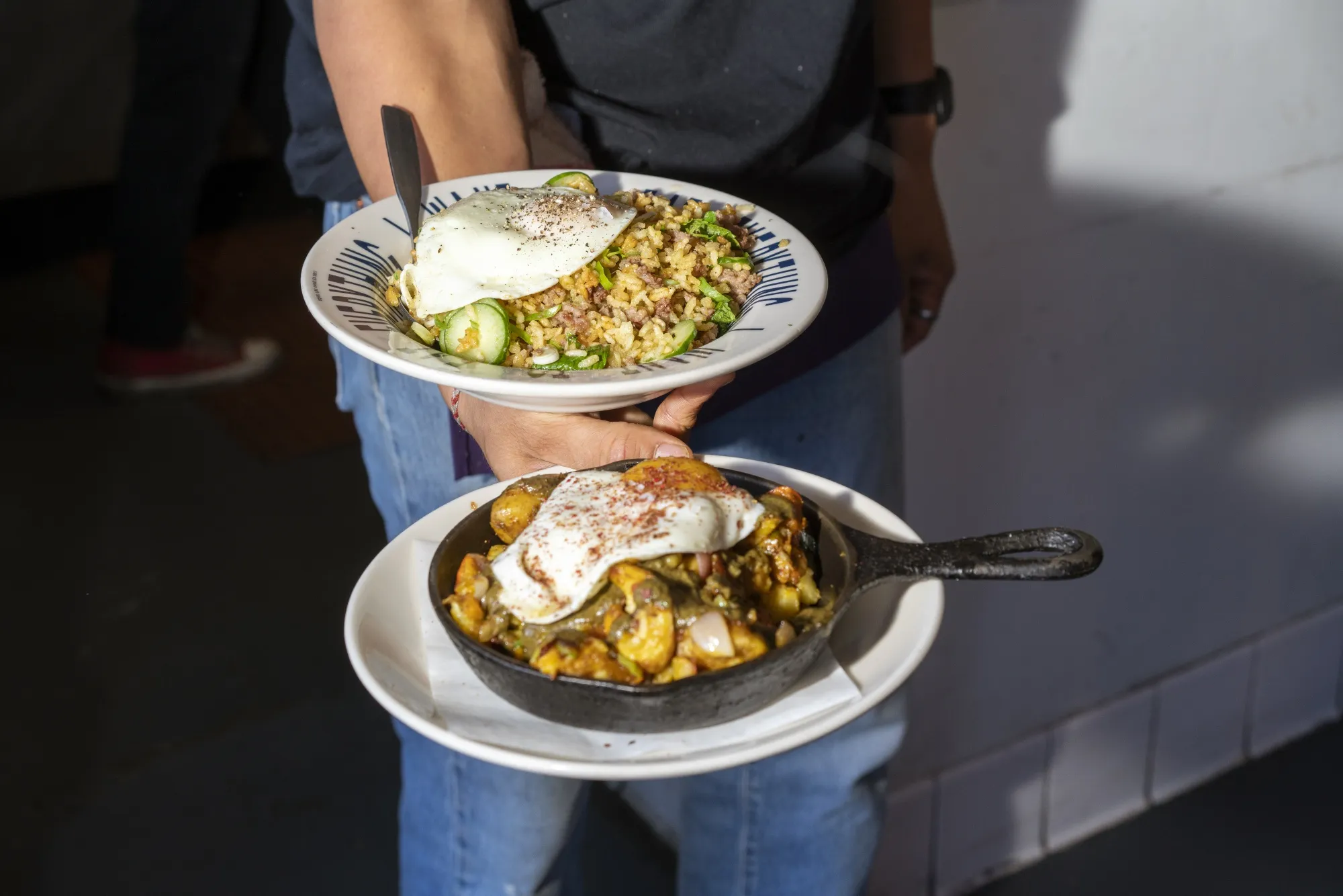 Meals are carried to customers at the Sqirl restaurant in Los Angeles.