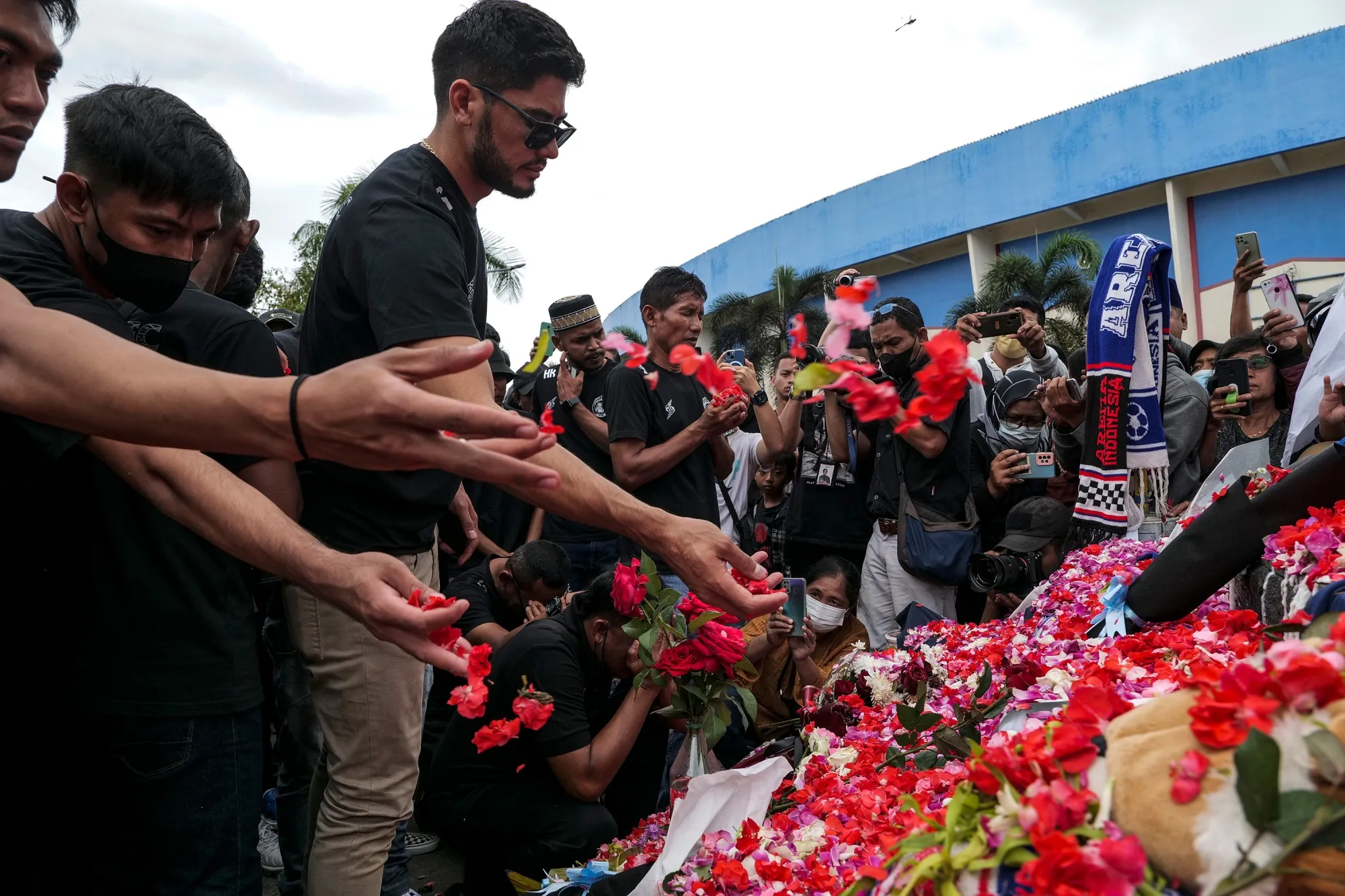 Players and officials of Arema FC&nbsp;pay condolences to the victims of the stampede outside Kanjuruhan Stadium&nbsp;in Malang, Indonesia, on Oct. 3.&nbsp;