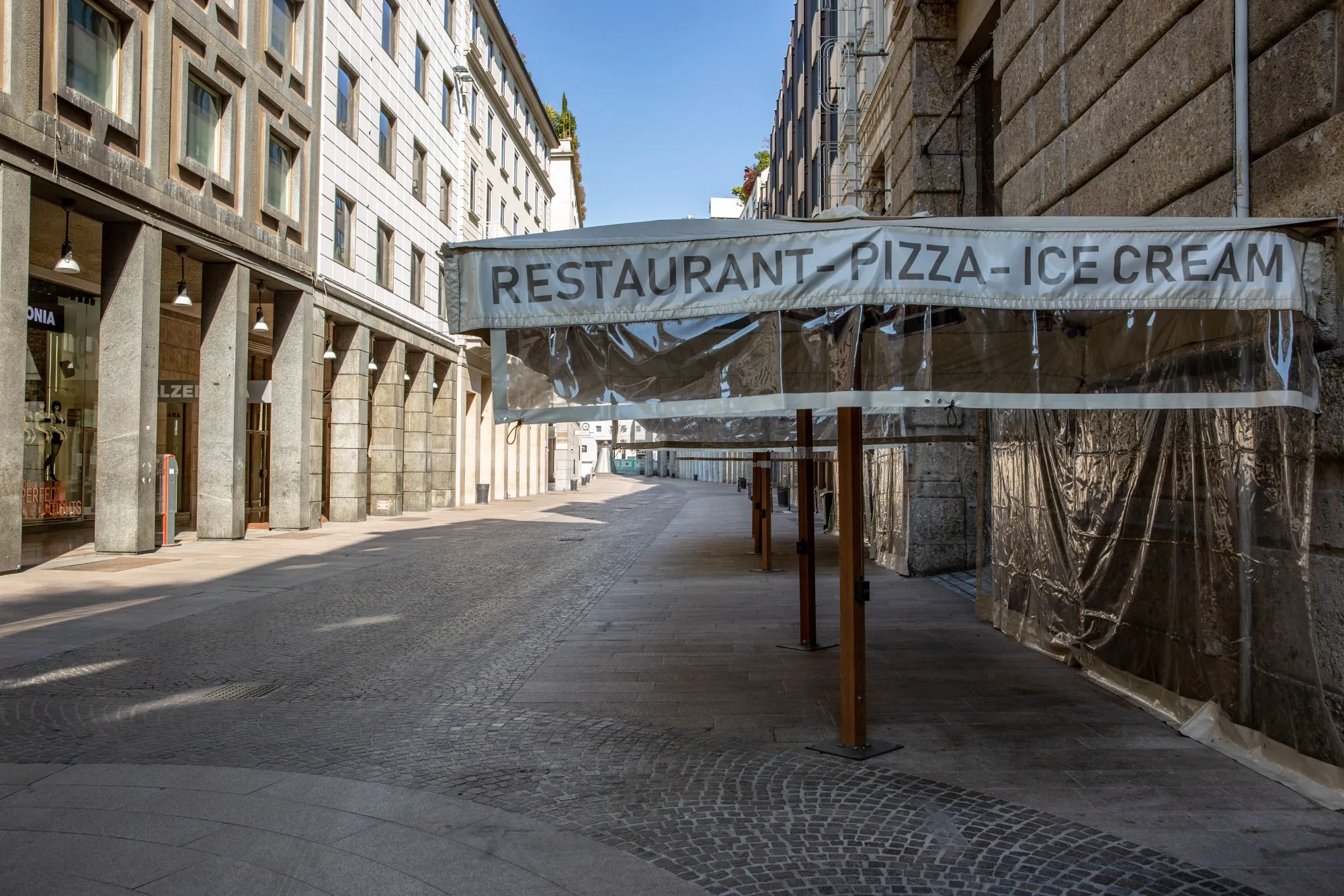 Parasols stand outside closed restaurants in Milan.