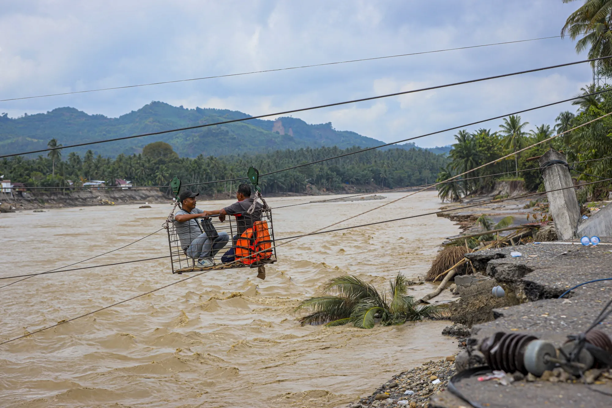 Villagers cross a river in a&nbsp;makeshift cable car after a flash flood in&nbsp;Aceh, Indonesia this month.