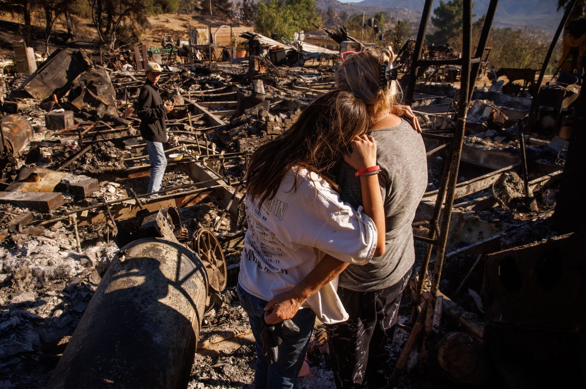 A resident&nbsp;observes the remains of her home during the Highland Fire in Aguanga, California.