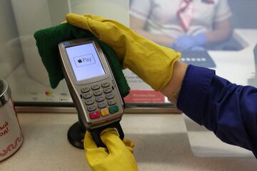 A worker disinfects a Verifone contactless electronic payment terminal in Moscow.