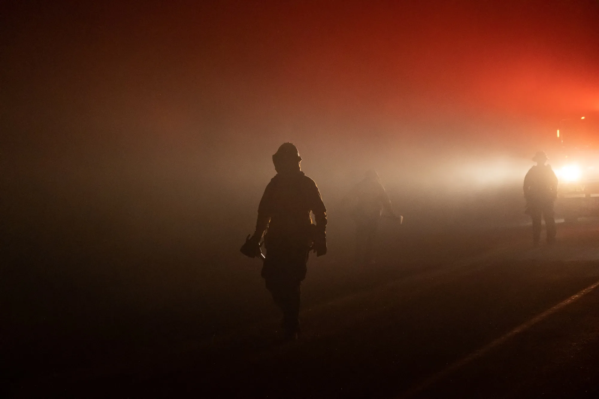 Firefighters walk towards a fire in the Indian Falls neighborhood during the Dixie Fire near Crescent Mills, California, on July 24.