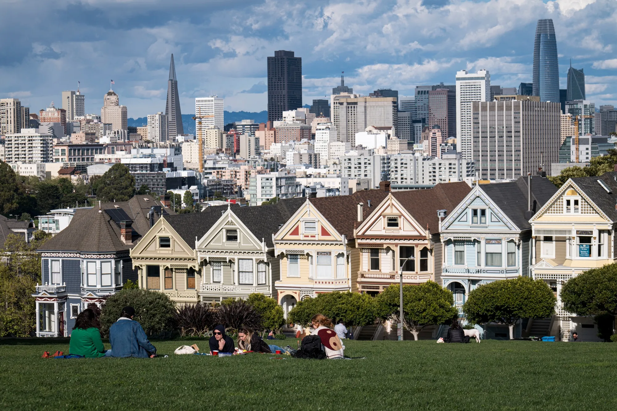 People sit in Alamo Square in San Francisco.
