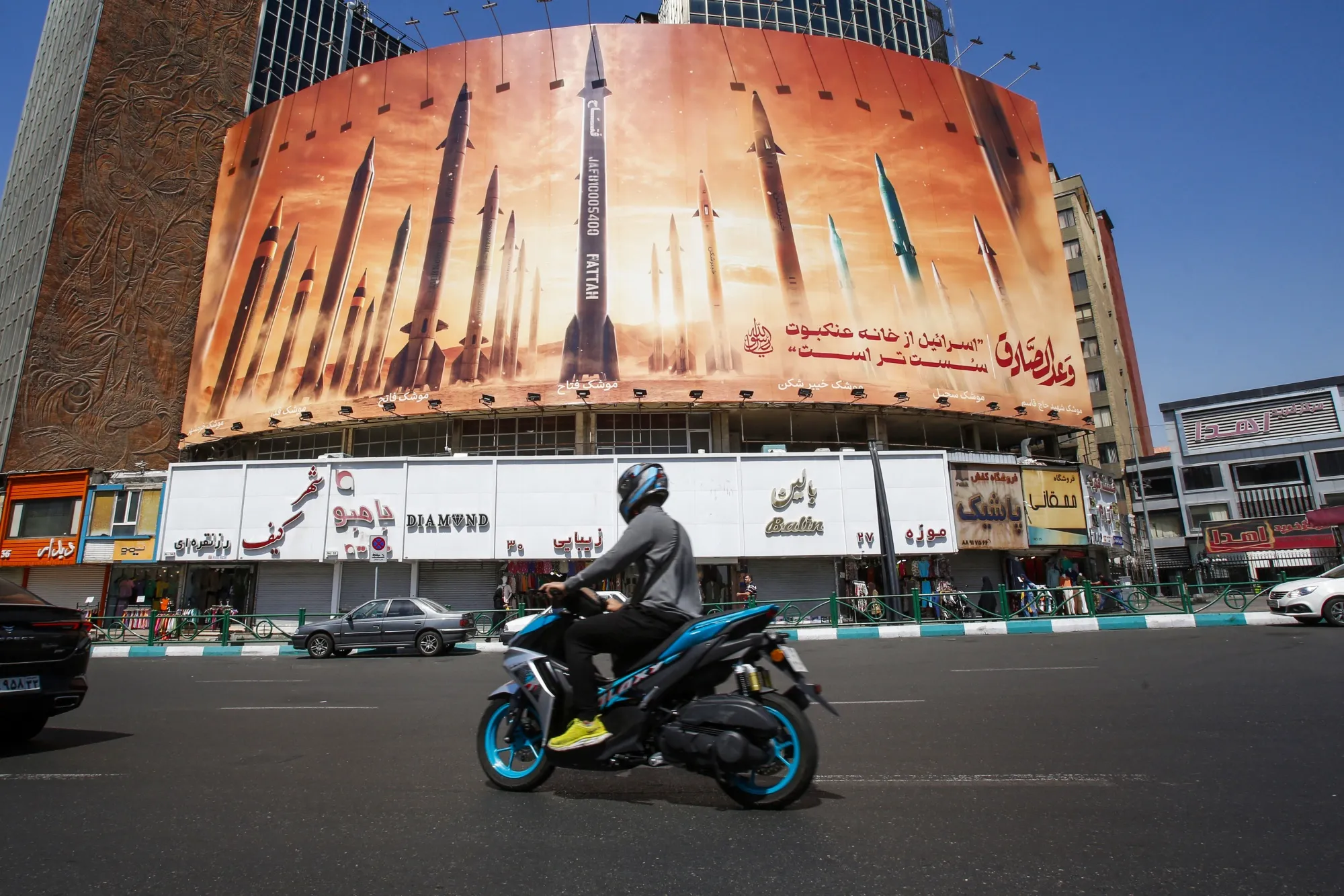 A motorist&nbsp;passes&nbsp;a billboard depicting Iranian ballistic missiles in Tehran on April 19.