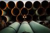 Miles of unused pipe, prepared for the proposed Keystone XL pipeline, sit in a lot on October 14, 2014 outside Gascoyne, North Dakota.