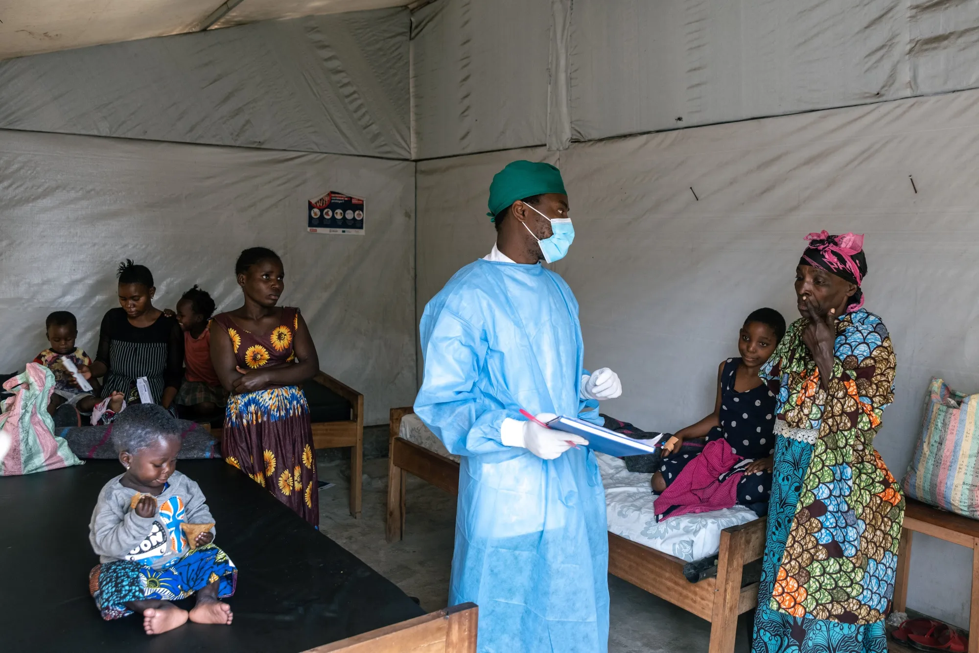 A health worker discusses treatments with patients at the Munigi mpox center in the Democratic Republic of the Congo.