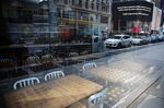 Chairs and tables sit inside a closed restaurant in Times Square in New York, U.S., on April 21.