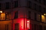 A&nbsp;hotel sign below residential buildings&nbsp;in Paris.
