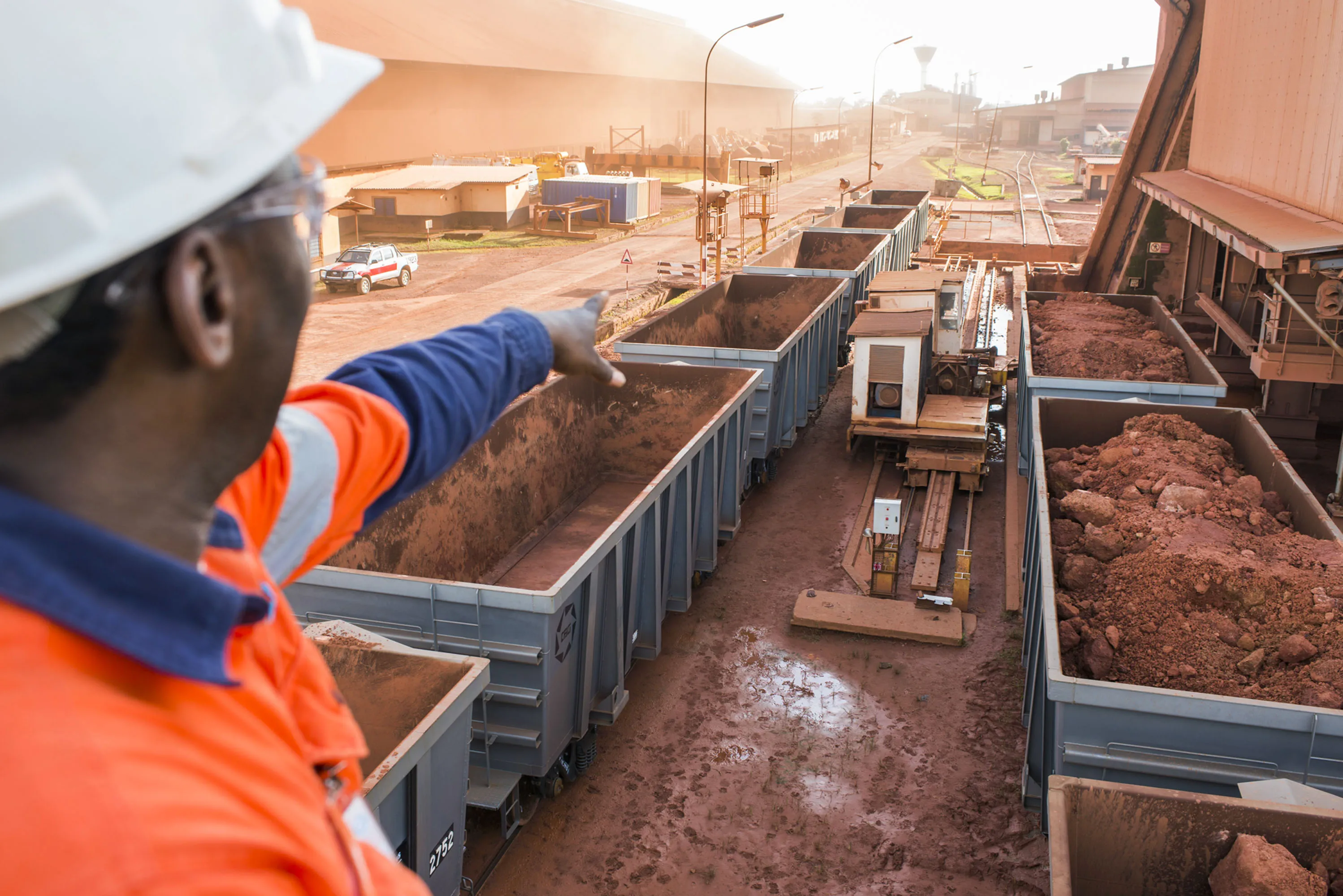 A worker gestures towards railway freight wagons&nbsp;in Kamsar, Guinea.&nbsp;
