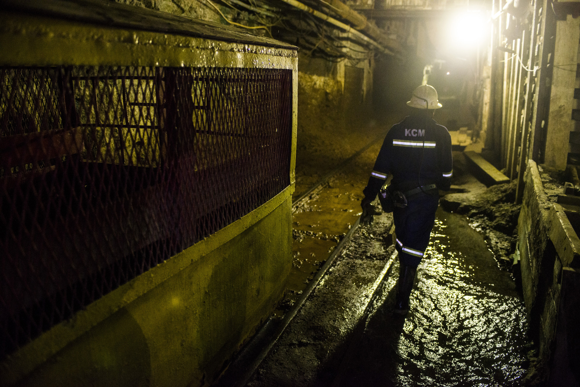 A miner walks along rail tracks in an underground tunnel at the Nchanga copper mine, operated by Konkola Copper Mines Plc, in Chingola, Zambia.