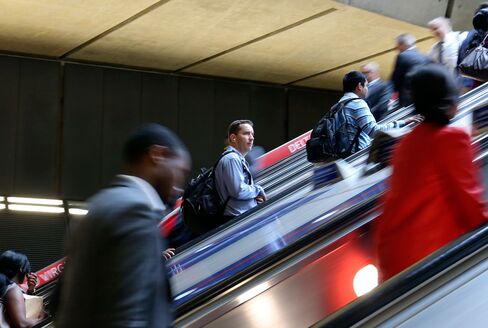 Commuters at Canary Wharf tube station in London.