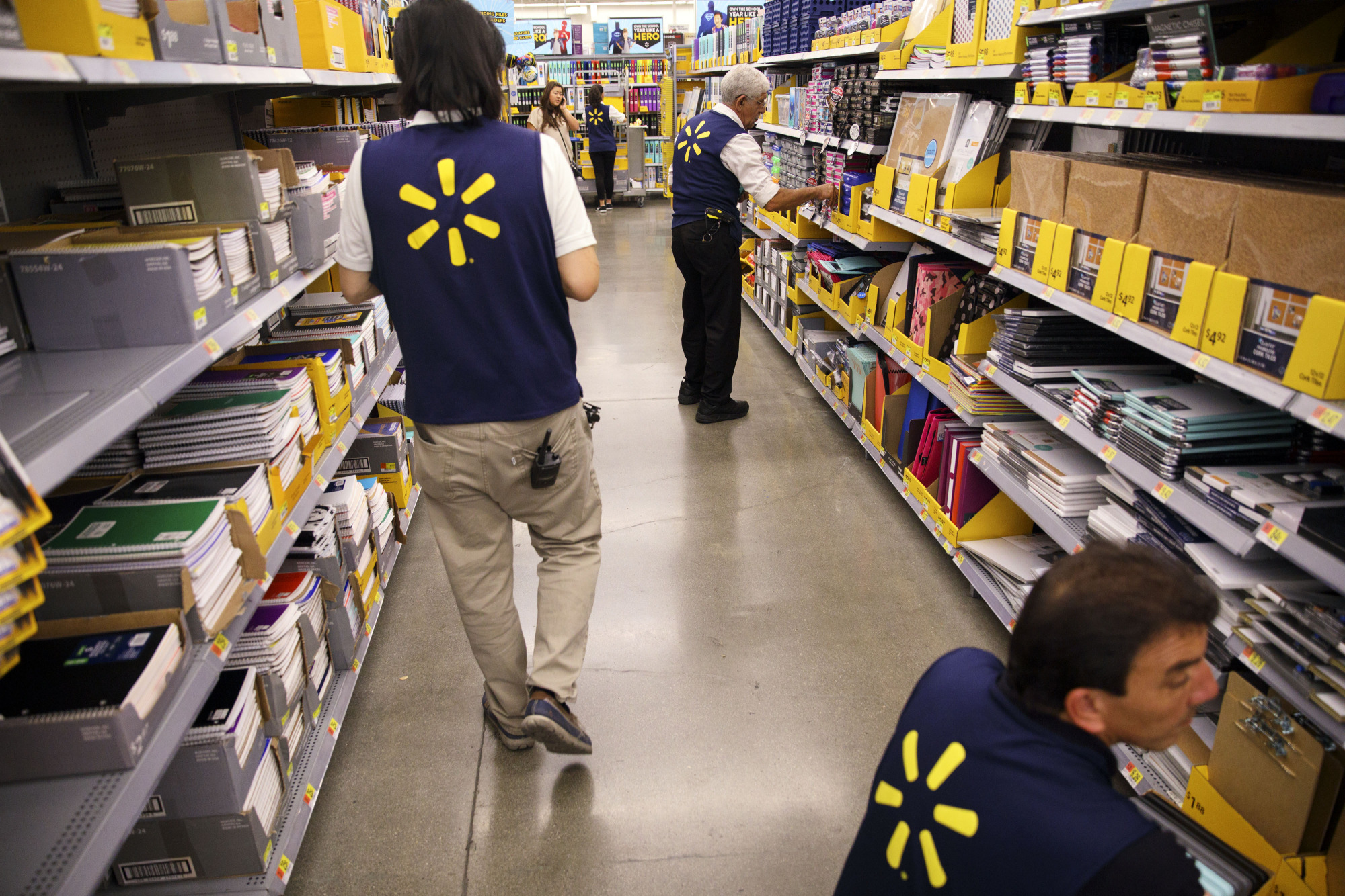 Employees restock shelves of school supplies at a Wal-Mart Stores Inc. location in Burbank, California, U.S.