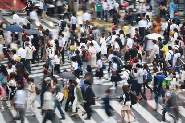 Pedestrians cross an intersection in the Shibuya district of Tokyo.