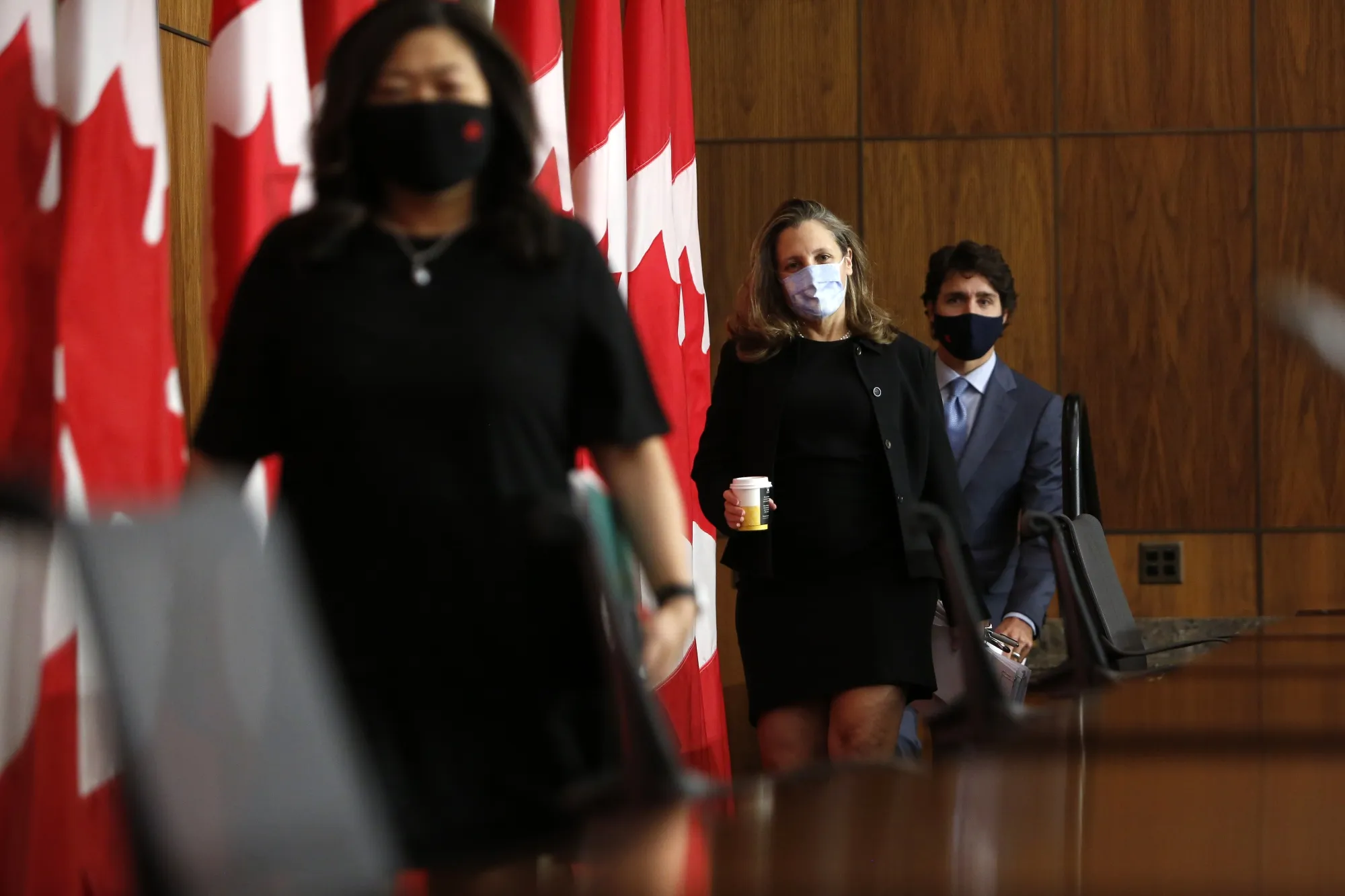 Chrystia Freeland, center, and Justin Trudeau leave an Ottawa news conference in October 2020.