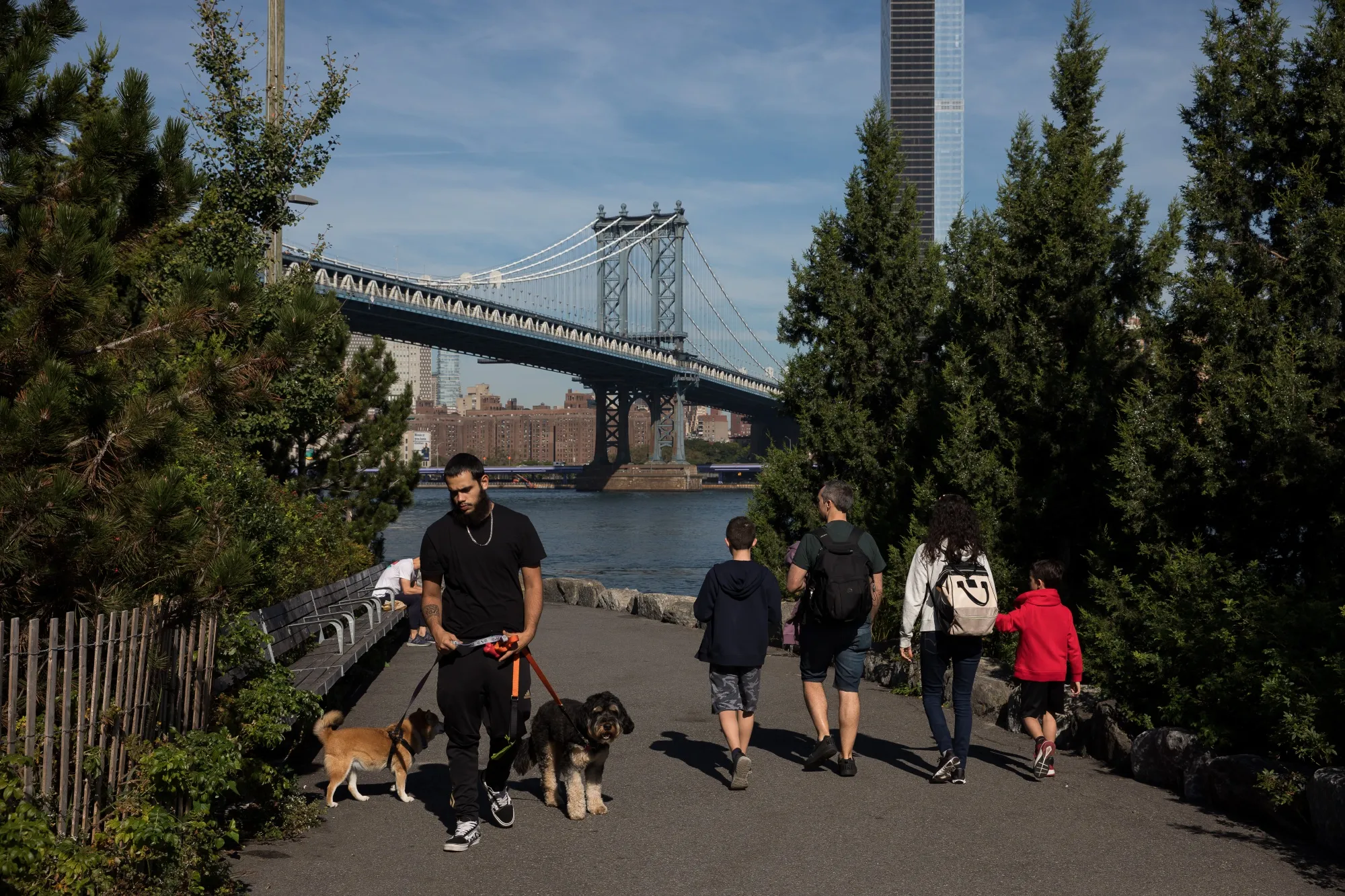 Pedestrians walk through John Street Park in the Brooklyn borough of New York.