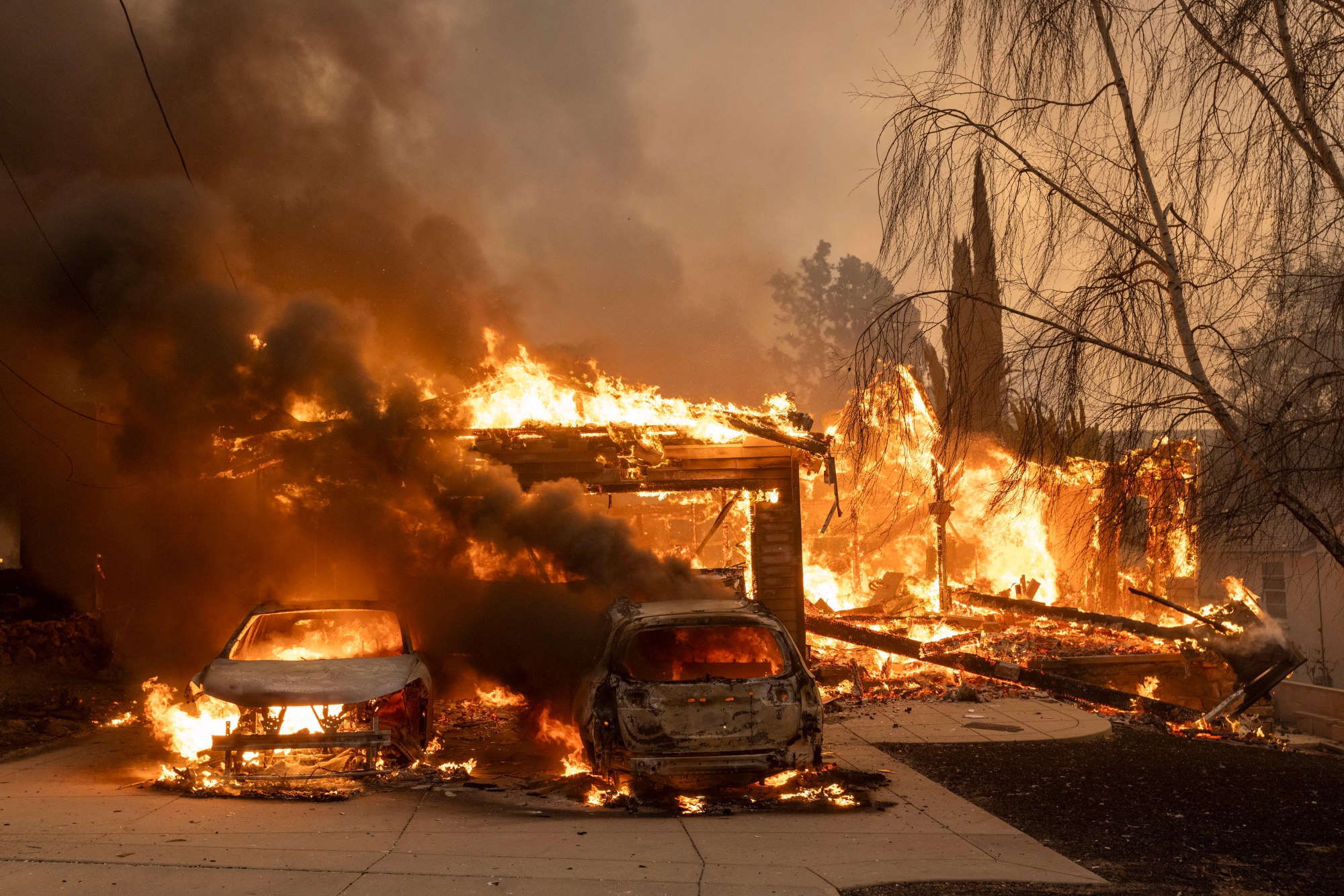 Vehicles burn during the Eaton Fire in Altadena, California, on Jan. 8.