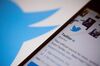 The Twitter Inc. logo is seen behind an Apple Inc. iPhone 6s displaying the company's mobile application in this arranged photograph taken in New York, U.S., on Tuesday, Feb. 9, 2016. Twitter Inc. is changing its timeline to display popular tweets first, instead of the latest posts, a long-anticipated step thats likely to anger its most passionate users. Twitter is scheduled to report quarterly earnings results following the close of U.S. financial markets on February 10.