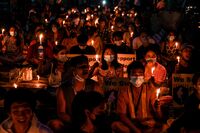 Protesters taking part in a candlelight demonstration against the military coup in Yangon's Tamwe township on April 3.