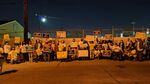 Environmental activists with Singleton United protest at an asphalt shingle plant in West Dallas in 2021. 