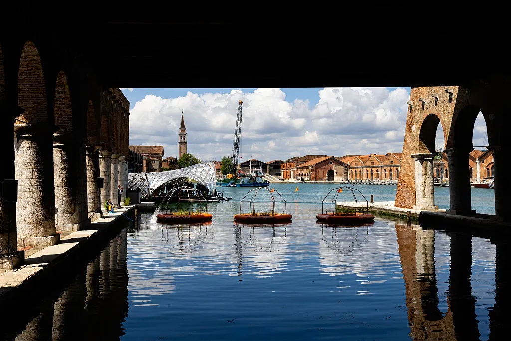Visitors explore the outdoor installations of the main exhibition at the Arsenale during the press preview of the 2025 Venice Architecture Biennale.