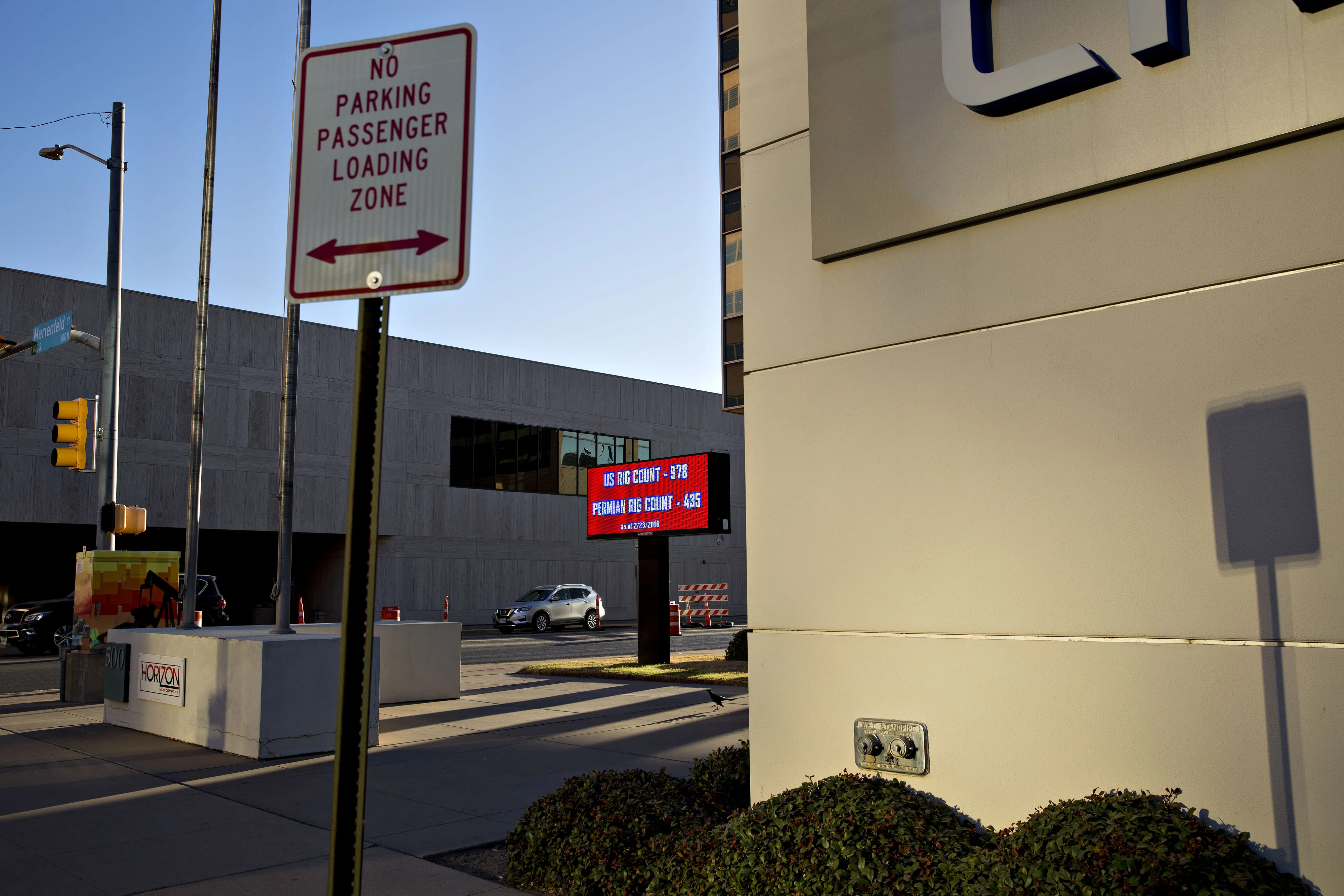 An electronic sign displays the number of oil rigs operating in the U.S. and the Permian Basin outside an office building in downtown Midland, Texas, on March 1, 2018.&nbsp;