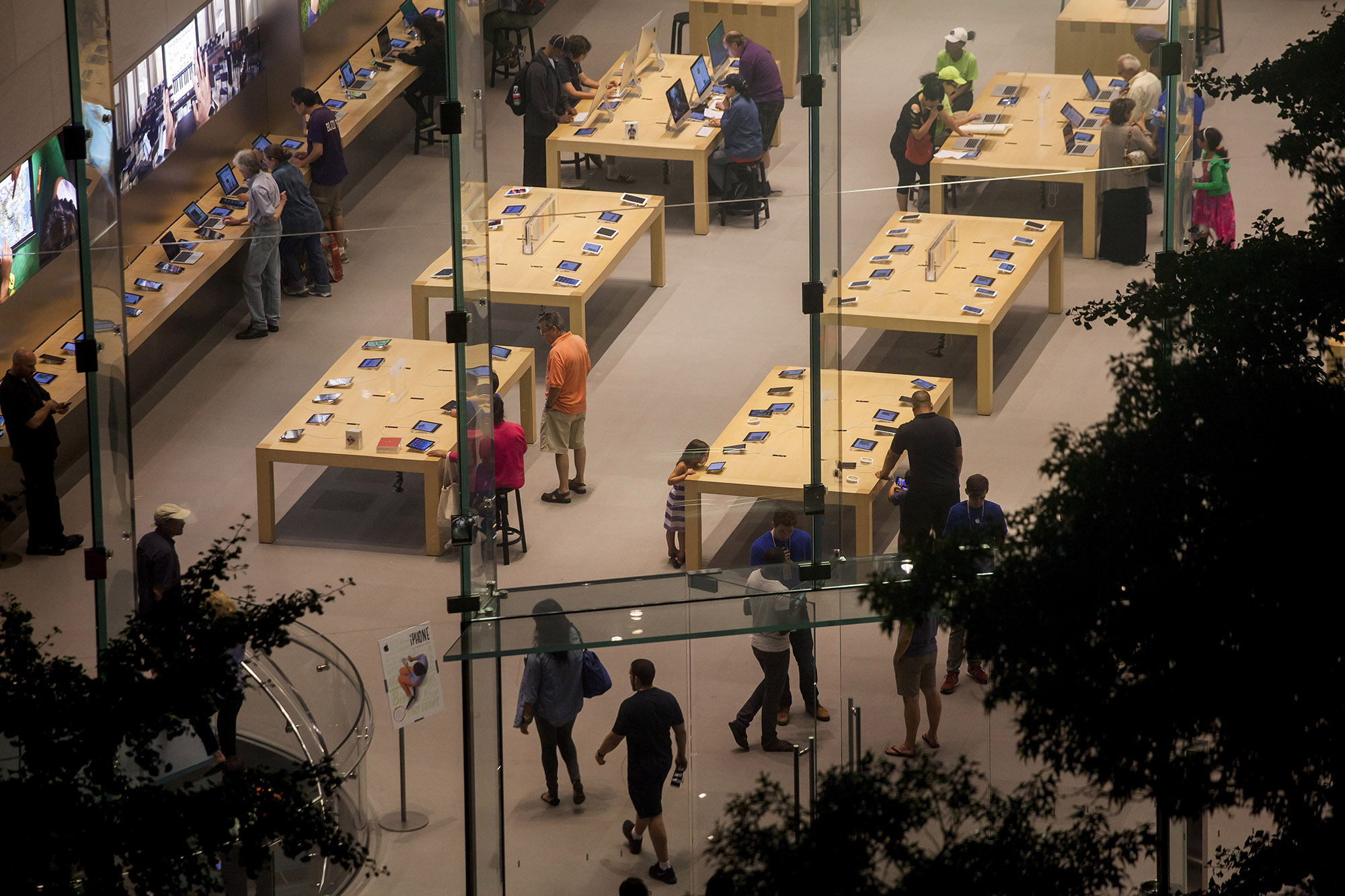 Shoppers look at products at the Upper West Side Apple Inc. store in New York.