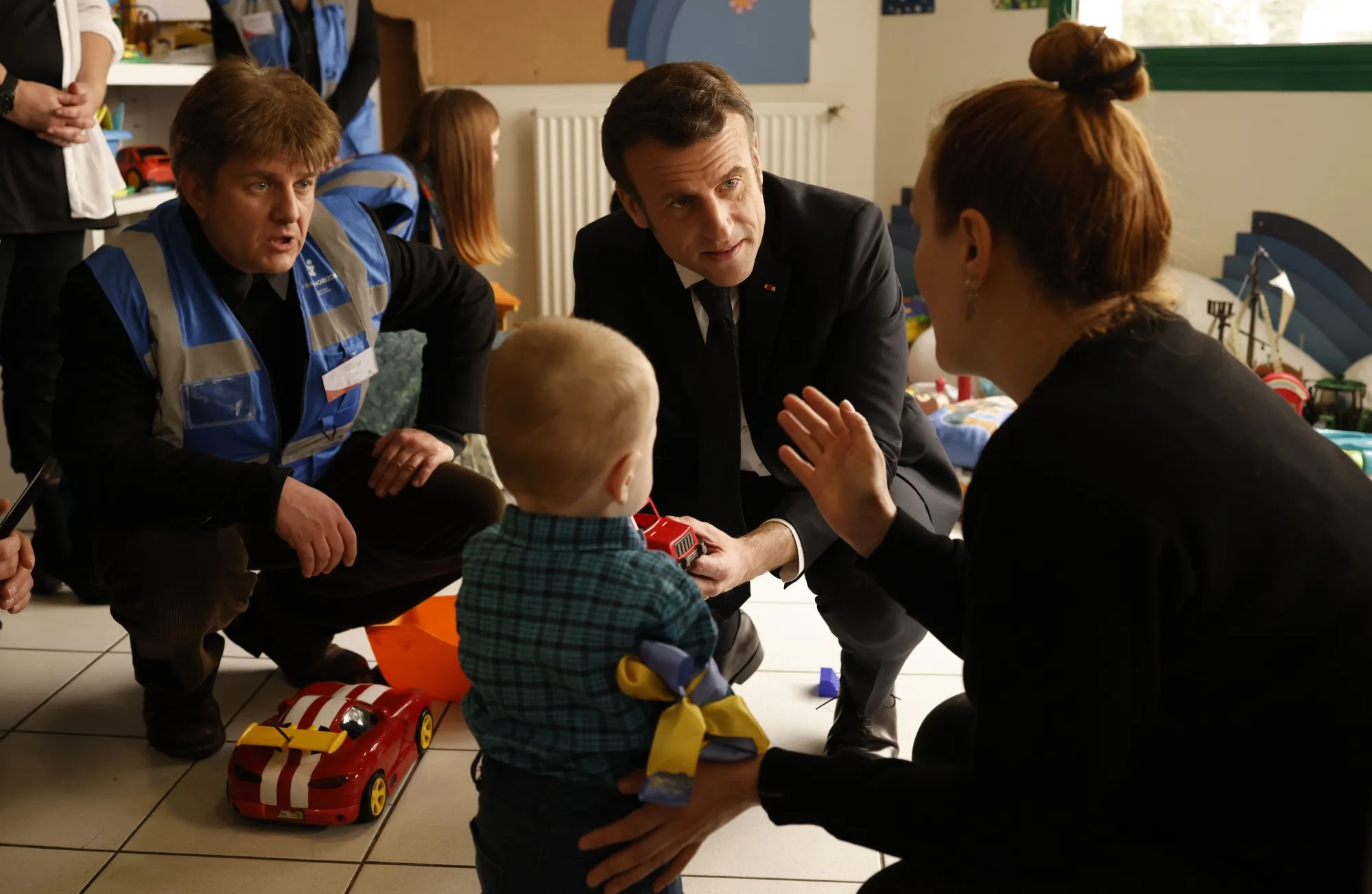 French President Emmanuel Macron, second right, listens to a woman refugee as he visits a center for Ukrainian refugees in La Pommeraye, near Mauges-sur-Loire, western France, Tuesday, March 15 2022. The center, run by the group France Horizon, houses around fifty refugees who arrived on March 12 after fleeing the war in Ukraine. (Yoan Valat, Pool via AP)