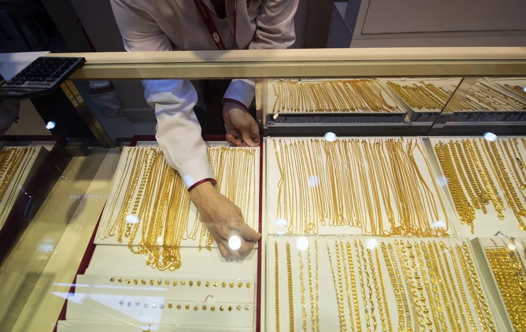 Gold necklaces for sale in a display cabinet in Singapore.
