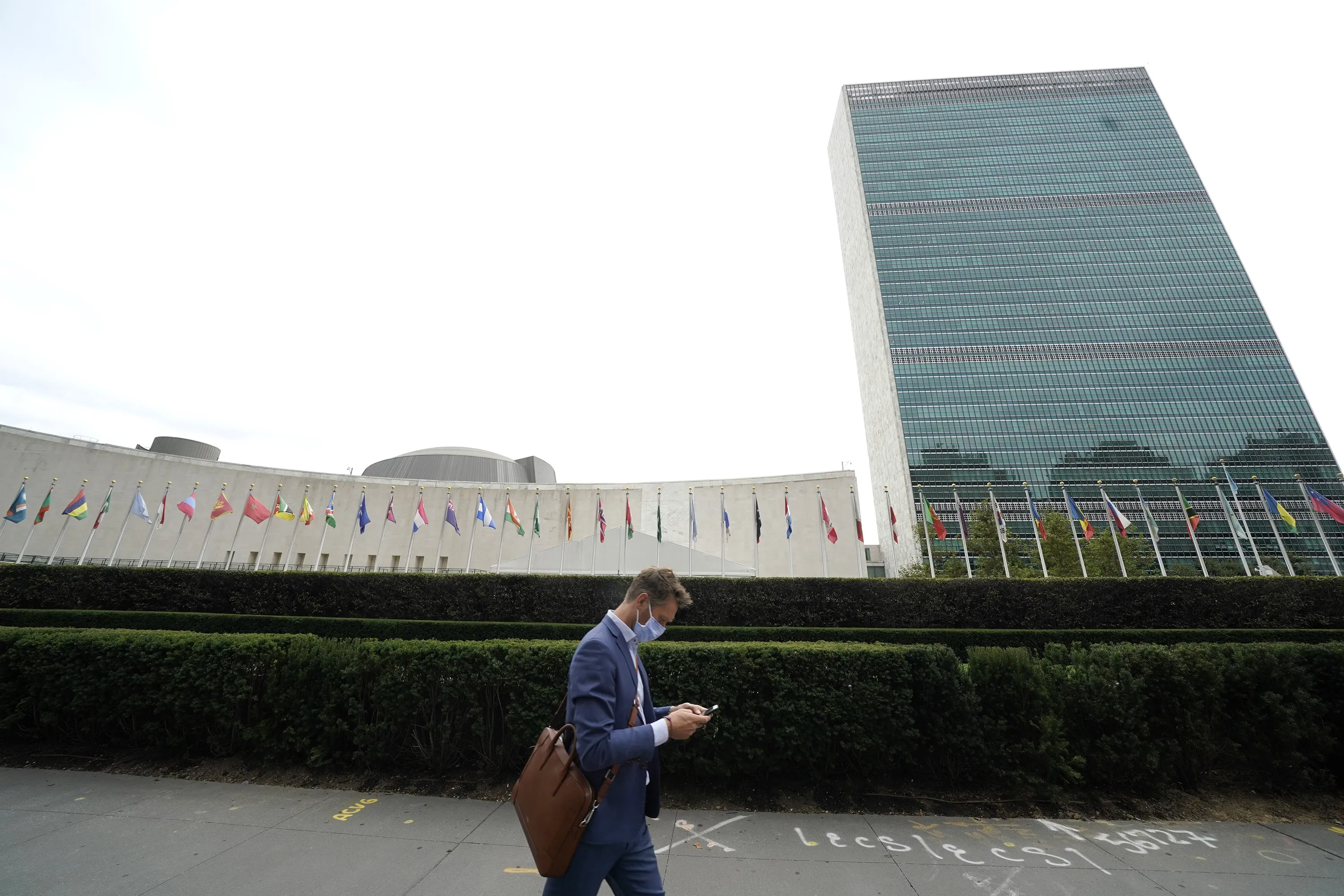 A man passes the UN headquarters in New York. The UN General Assembly that usually brings about 10,000 diplomats to Manhattan is being held virtually this week.