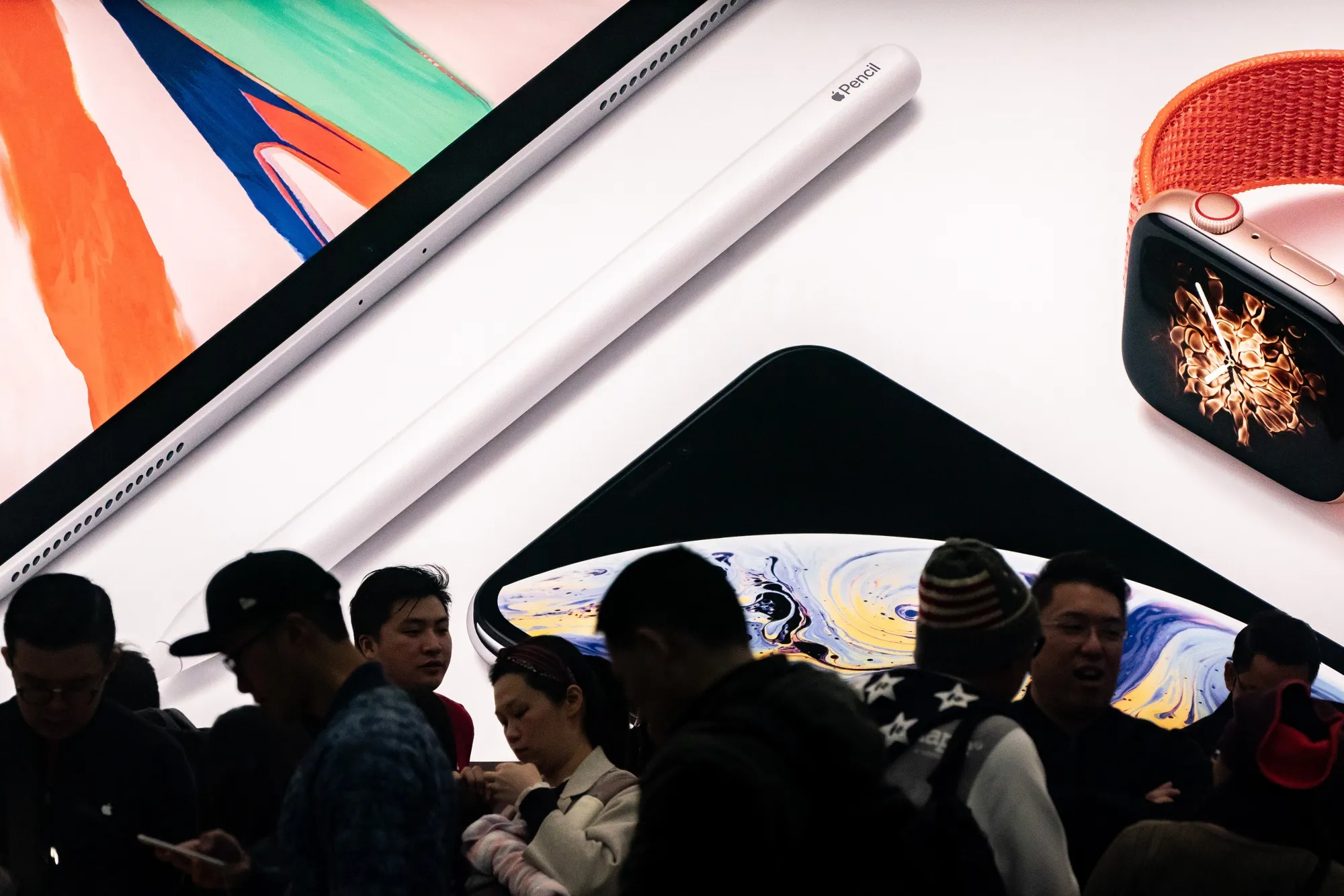 Customers browse inside an Apple Inc. store in Hong Kong, China.