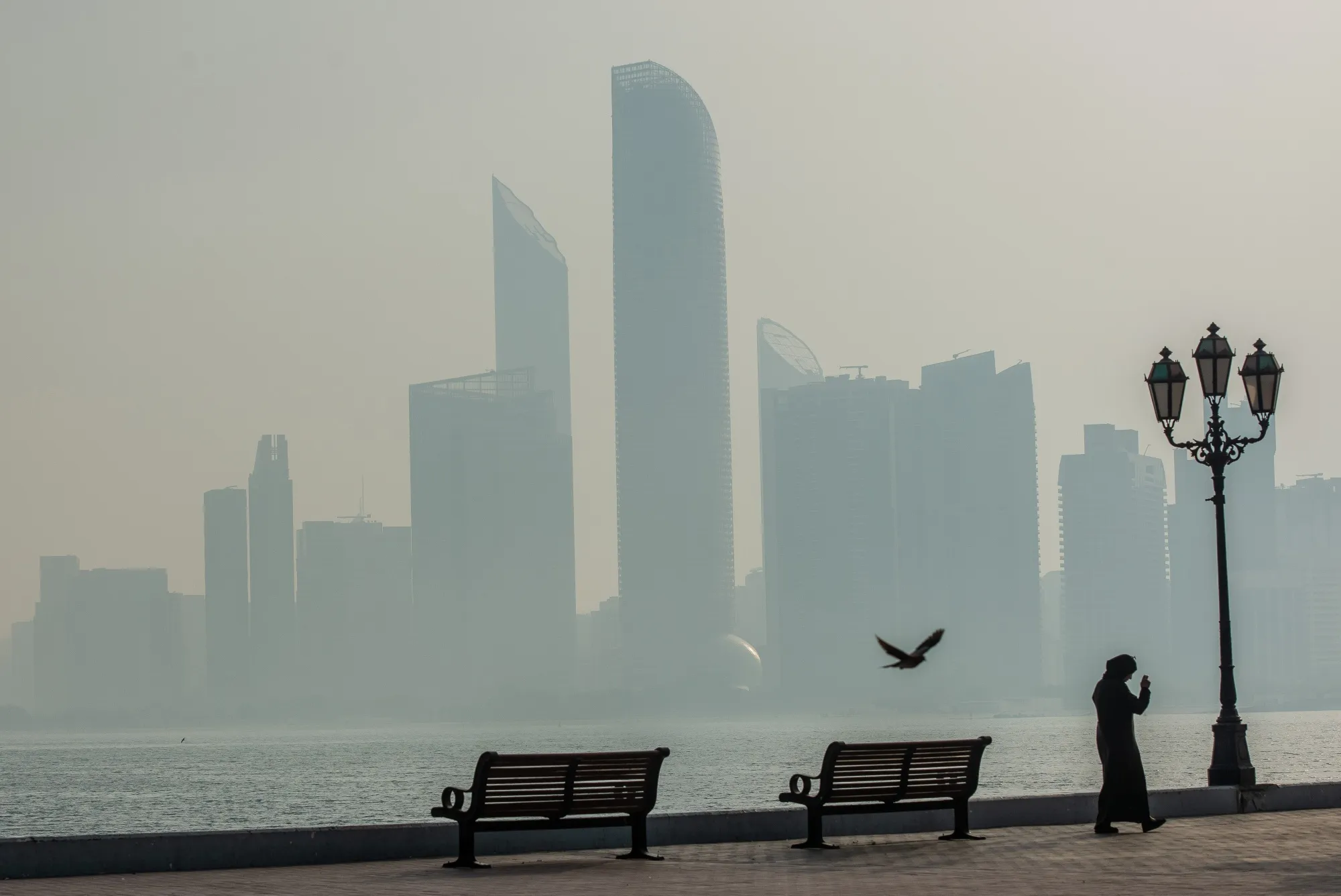 Commercial and residential buildings visible through the haze in Abu Dhabi, United Arab Emirates.&nbsp;