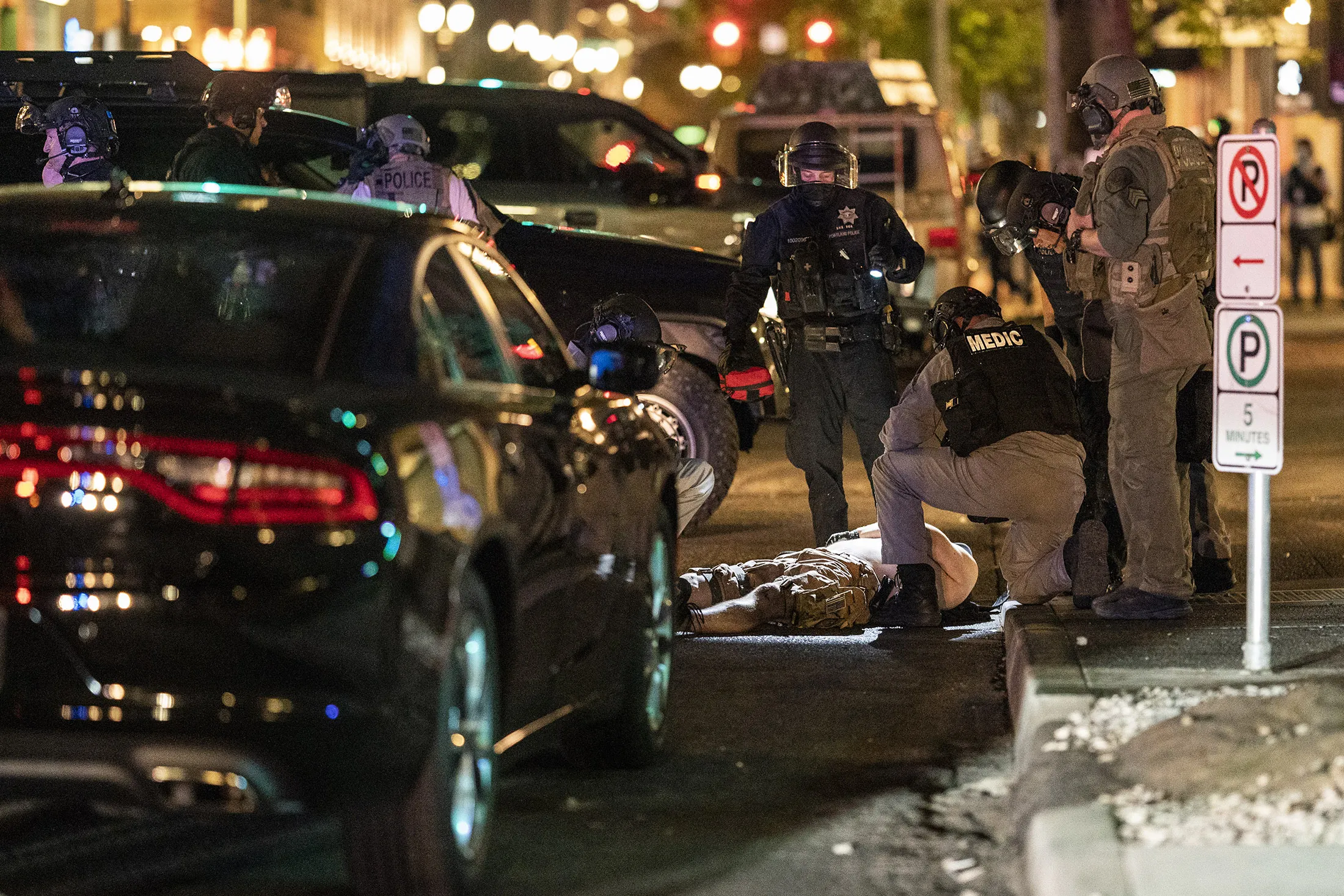 Police arrive to treat a man who was shot near a pro-Trump rally on Aug. 29.&nbsp;