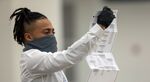 A worker with the Detroit Department of Elections inspects an absentee ballot in Detroit, Michigan, on Nov. 4.