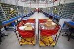 Parcels in trolleys at a&nbsp;Royal Mail Plc sorting office in Chelmsford, U.K.