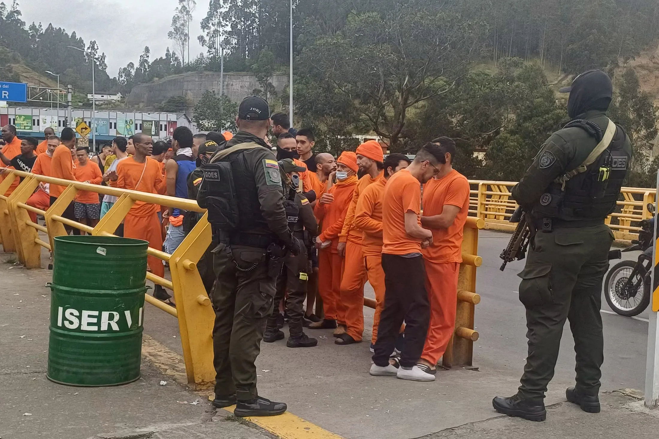 Inmates wait in line before being deported to Colombia at the Rumichaca international bridge in Tulcan, Ecuador, on July 26.