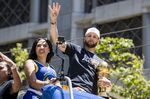 Golden State Warriors' Stephen Curry accompanied by his wife Ayesha, left, holds the Larry O'Brien trophy during the NBA Championship parade in San Francisco, Monday, June 20, 2022, in San Francisco. (AP Photo/John Hefti)