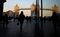 Pedestrians walk through the More London office space as Tower Bridge is reflected in the glass window of an office building in London, U.K., on Tuesday, Feb. 17, 2015. The FTSE 100 Index added 7.53 points, or 0.1 percent, to 6,905.66 at 9:47 a.m. in London, leaving the gauge about 25 points away from the all-time high reached in December 1999. Photographer: Simon Dawson/Bloomberg