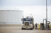 A worker unloads crude oil from a tanker at an Enterprise Crude Pipeline LLC storage facility in Loving County Texas, U.S., on Monday, Dec. 17, 2018. Once the shining star of the oil business, gasoline has turned into such a drag on profits that U.S. refiners could be forced to slow production in response.