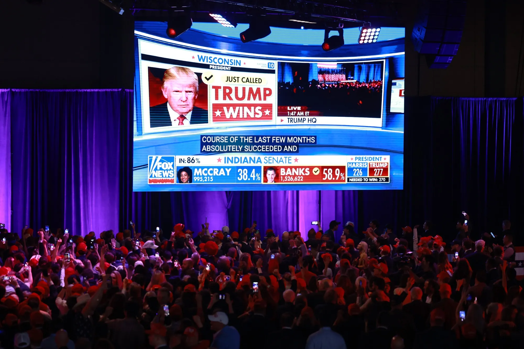 Supporters take photos as Fox News projects Donald Trump is elected president during an election night event at the Palm Beach Convention Center in West Palm Beach, Florida, on Nov. 6.