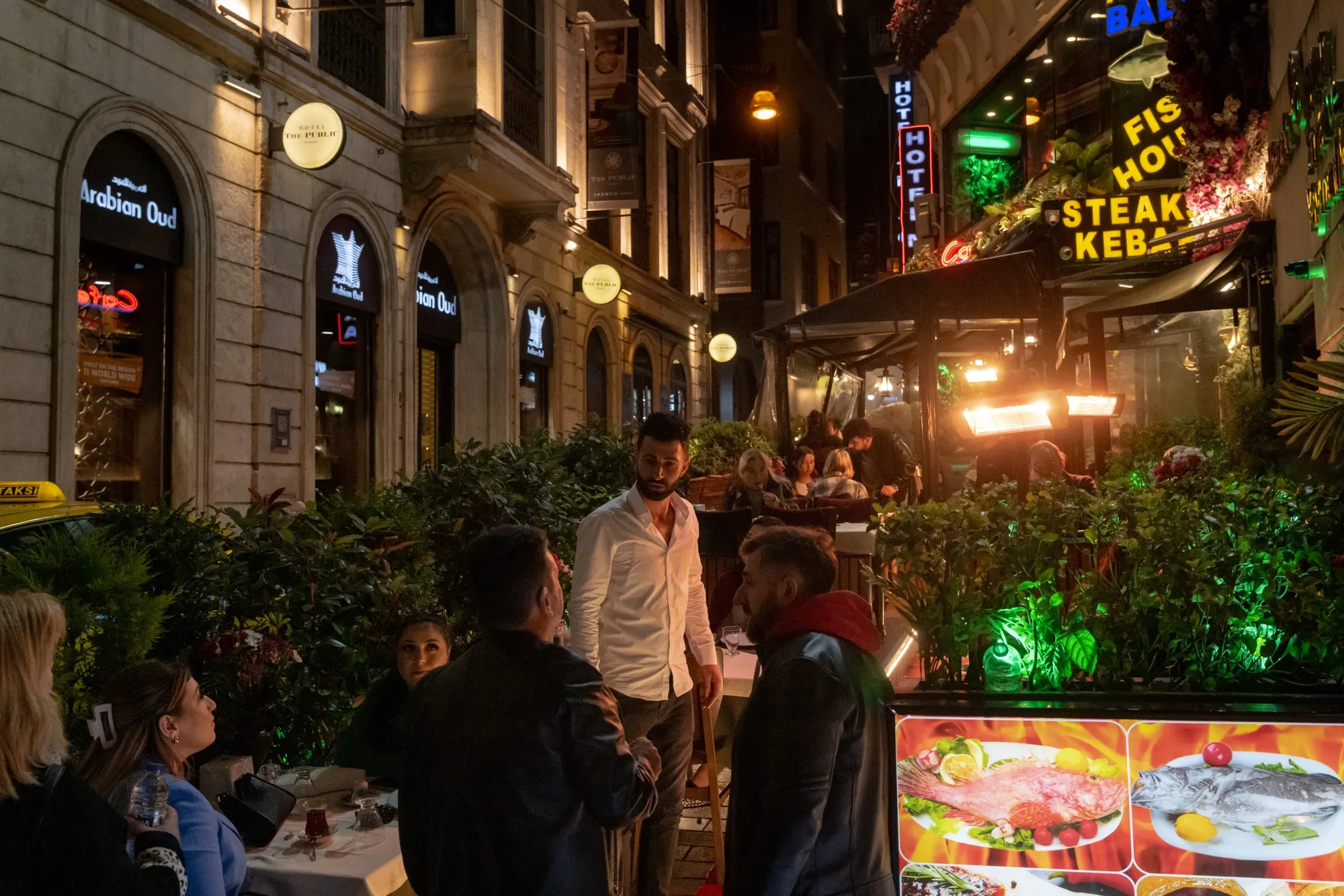 A waiter greets customers at a restaurant on Istiklal Street in Istanbul.&nbsp;