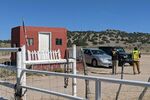 Security guards stand at the entrance of Bonanza Creek Ranch in Santa Fe, New Mexico, on Oct. 22.