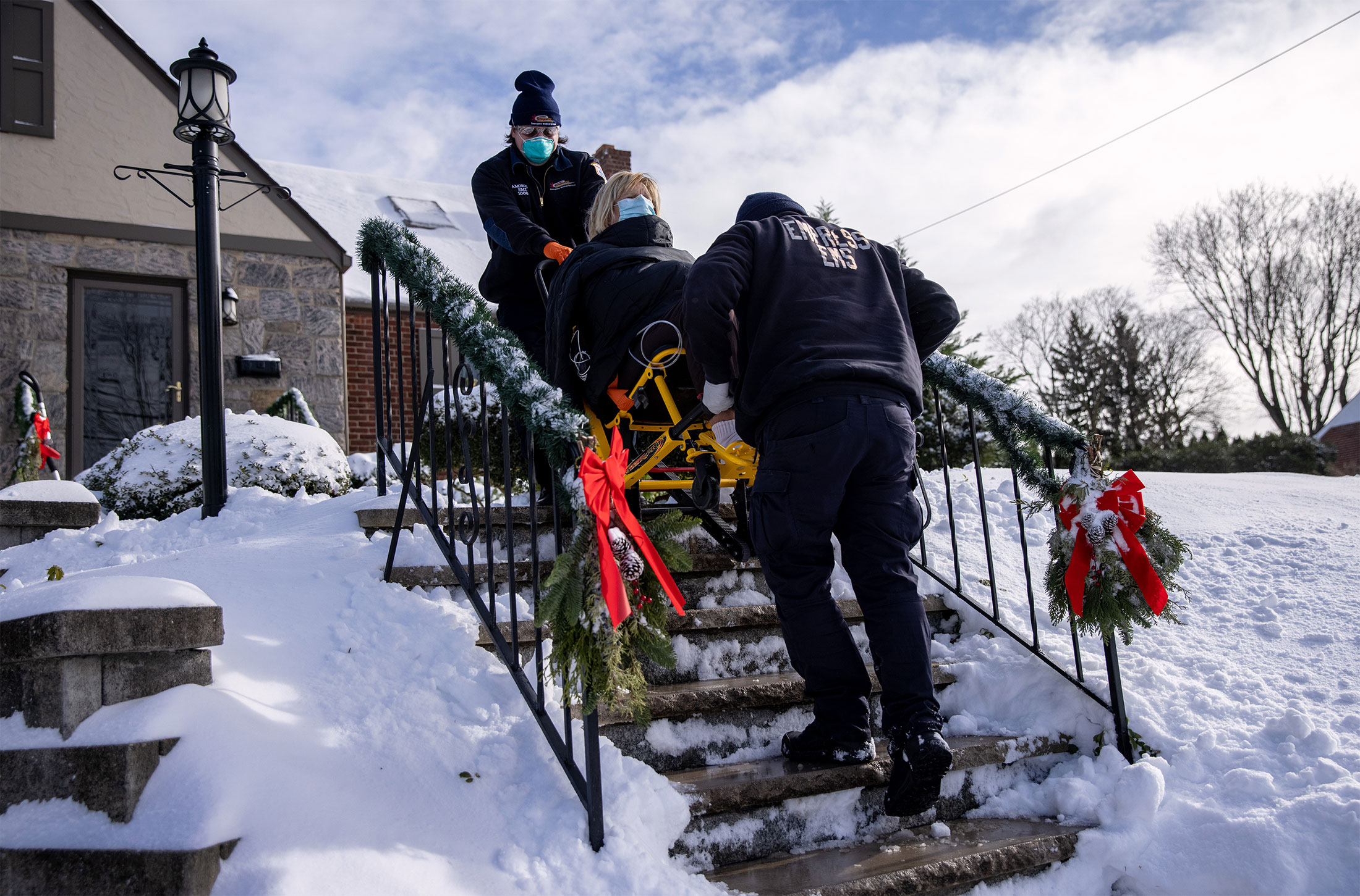 Paramedics transport a woman with symptoms of COVID-19 to a hospital in Yonkers, New York, December 17, 2020.