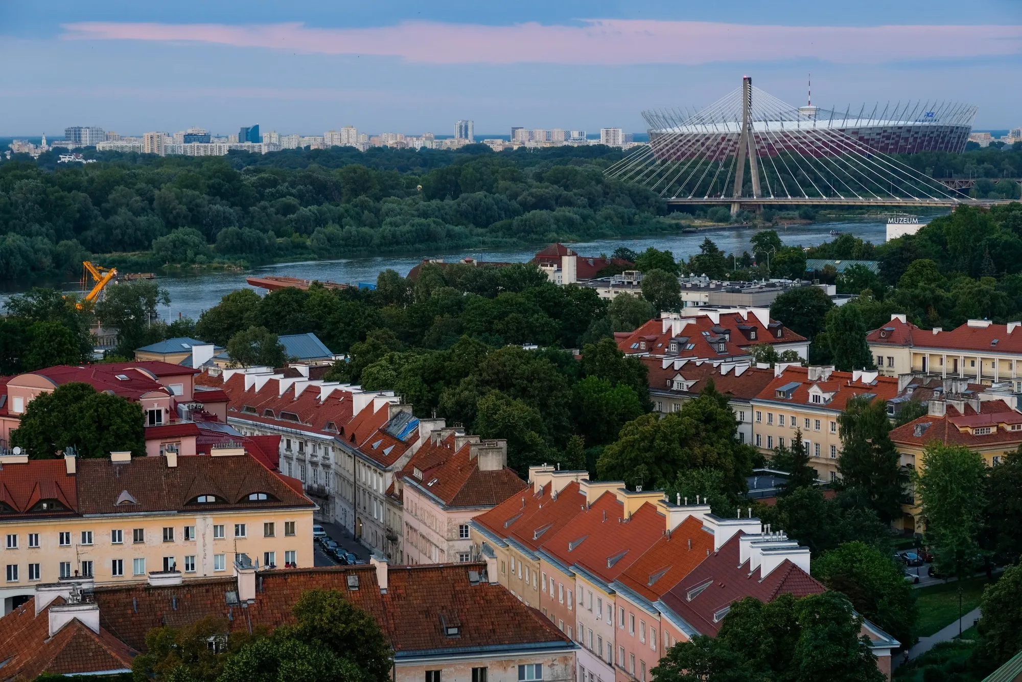 Homes in front of the Vistula River, the Swietokrzyski Bridge, and the PGE National Stadium, in the old town area of Warsaw, Poland.